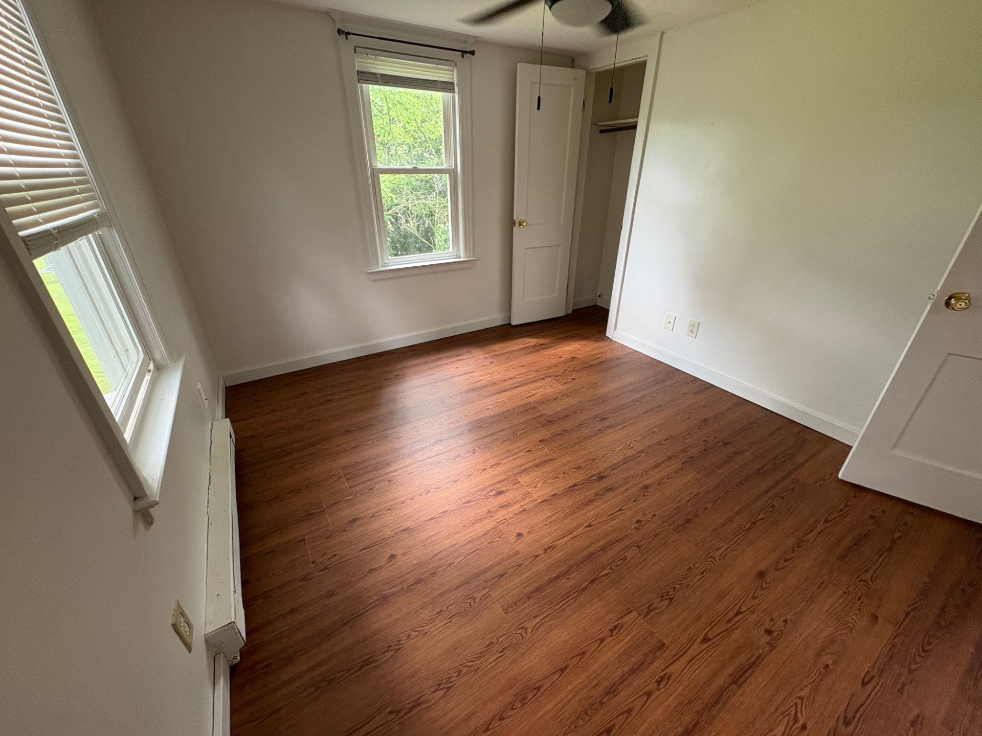 Bedroom refreshed with new wide plank LVP flooring and clean modern finish