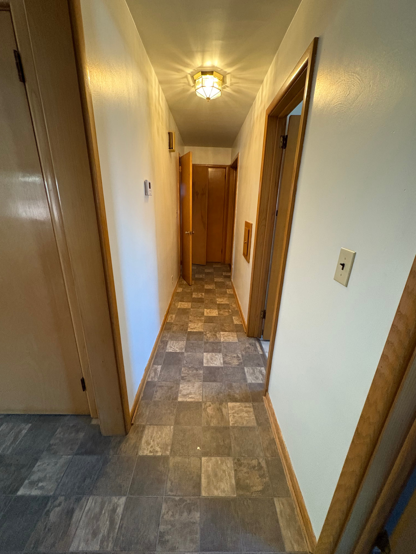 Long hallway brightened with fresh paint, clean trim and updated flooring after interior painting