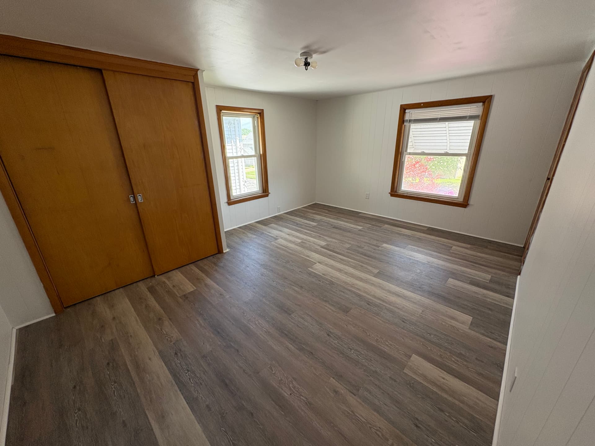 Bedroom finished with clean new LVP flooring, bright trim and a tidy modern look